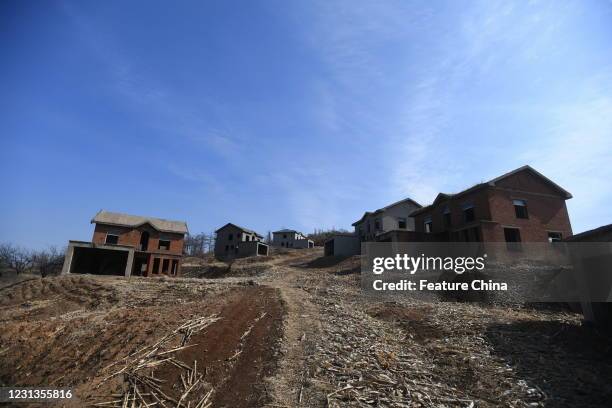 View of unfinished villa buildings in a real estate project deserted for over two decades in Shenyang in northeast China's Liaoning province...