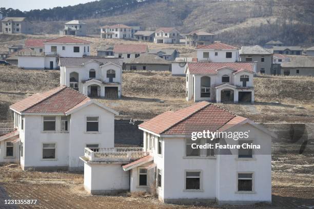 View of unfinished villa buildings in a real estate project deserted for over two decades in Shenyang in northeast China's Liaoning province...