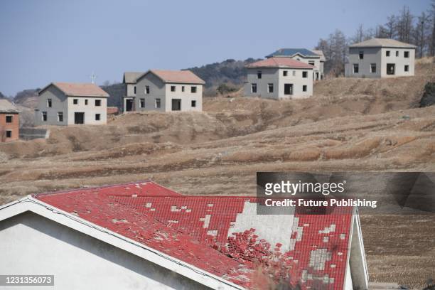 View of unfinished villa buildings in a real estate project deserted for over two decades in Shenyang in northeast China's Liaoning province...