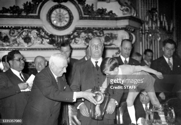 The president of the Federation Internationale de Football Association , Frenchman Jules Rimet , holds the urn for his grandson Yves 05 May 1938 in...