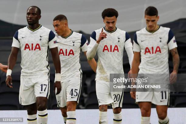Tottenham Hotspur's English midfielder Dele Alli celebrates with teammates after he scores his team's opening goal during the UEFA Europa League Last...