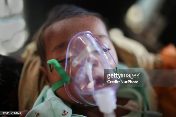 Baby who is suffering from respiratory disease receives treatment inside at Dhaka Shishu Hospital in Dhaka, Bangladesh on February 24, 2021. Children...