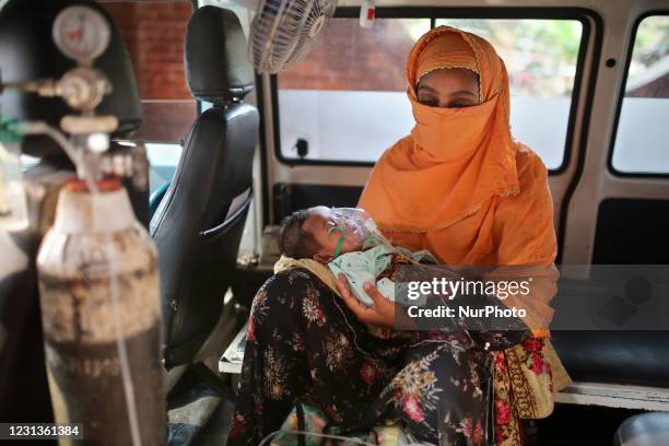 Baby who is suffering from respiratory disease receives treatment inside an Ambulance at Dhaka Shishu Hospital in Dhaka, Bangladesh on February 24,...