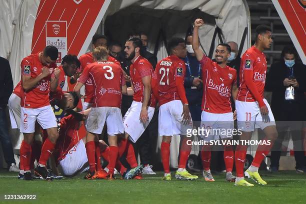 Nimes' players celebrate after scoring during the French L1 football match between Nimes Olympique and FC Lorient at the Costieres Stadium in Nimes,...
