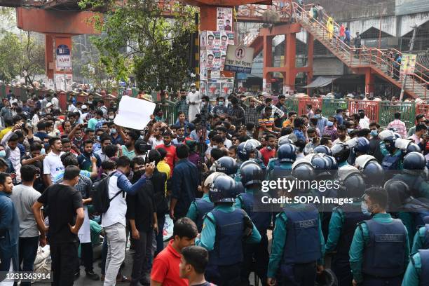 Police officers confront protesters at Dhakas Science lab intersection road during the demonstration. Thousands of students from seven colleges and...