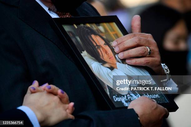 Jaime Puerta, holds a portrait of his son Daniel Puerta-Johnson, who died in April 2020 at the age of 16 from a pill containing fentanyl, during a...