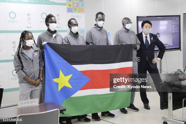 Ryu Yamamoto , mayor of the eastern Japan city of Maebashi, and South Sudanese athletes pose for a photo at the city office in Gunma Prefecture on...