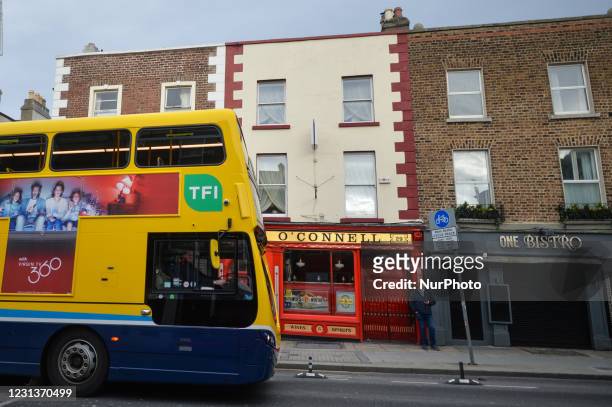 Manstands outside a closed pub and other business premises in Portobello area next to the Grand Canal in Dublin during Level 5 Covid-19 lockdown. On...