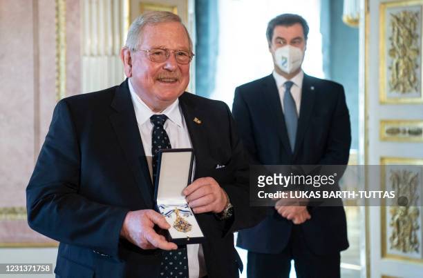 Bavaria's State Premier Markus Soeder and German Nobel Prize Laureate in Physics Reinhard Genzel pose during the awarding of the Bavarian...