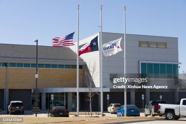 Feb. 24, 2021 -- Photo taken on Feb. 24, 2021 shows U.S. Flag, Texas flag, and Plano city flag lowered to half-staff in front of Plano Police Station...