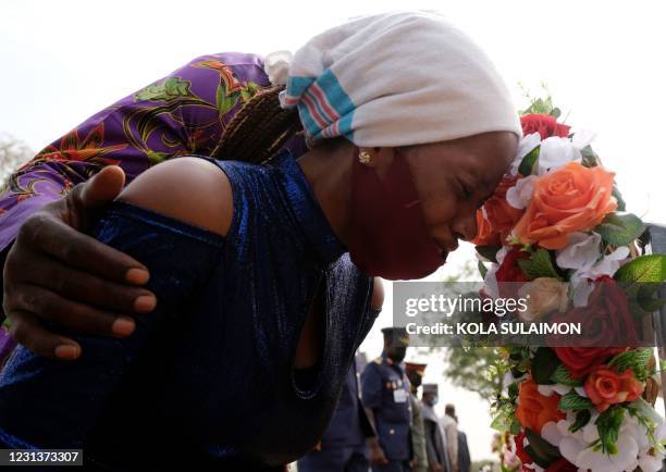 Widow cries during the funeral ceremony for seven military personel who died in the crash of their military aircraft at the National Military...