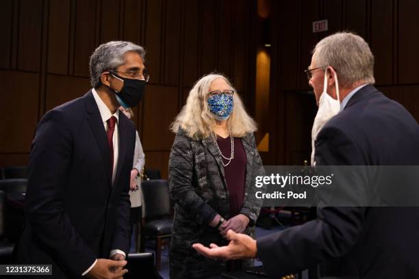 Vivek Murthy and Rachel Levine talk with Sen. Richard Burr prior to testifying at their confirmation hearing before the Senate Health, Education,...