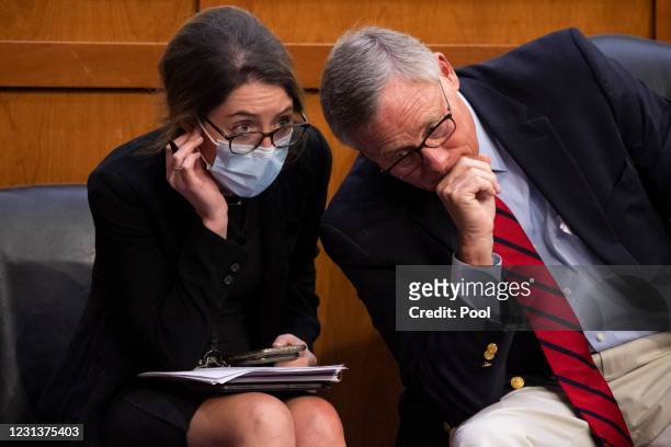 Sen. Richard Burr talks with a staffer during the confirmation hearings for Vivek Murthy and Rachel Levine before the Senate Health, Education,...