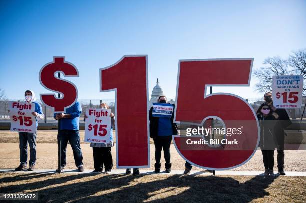 Activists with Our Revolution hold $15 minimum wage signs outside the Capitol complex on Thursday, Feb. 25 to call on Congress to pass the $15...