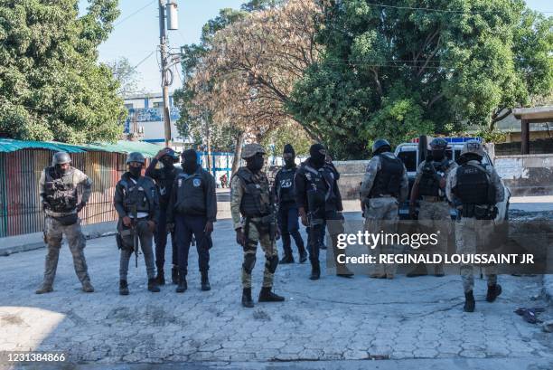 Several police officers from different specialized groups provide perimeter protection by the Croix-des-Bouquets prison from where many prisoners...