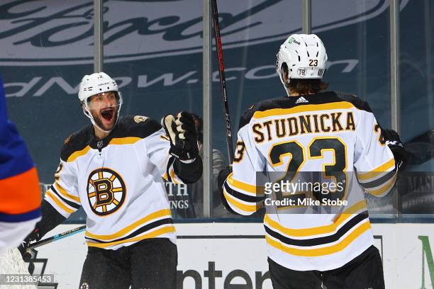 Craig Smith of the Boston Bruins is congratulated by Jack Studnicka after scoring a goal against the New York Islanders during the second period at...