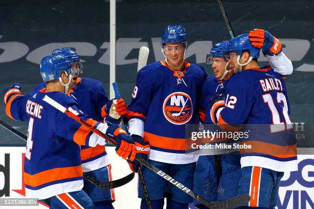 Anthony Beauvillier of the New York Islanders is congratulated by his teammates after scoring a goal against the Boston Bruins during the third...