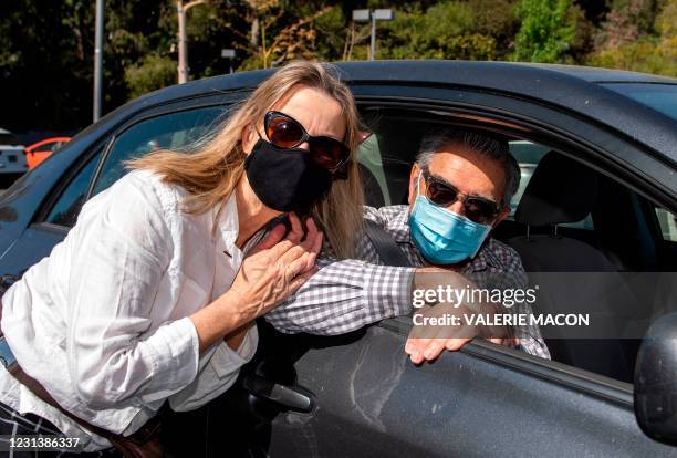 Actor Eugene Levy and his wife Deborah Divine arive at the Luxe hotel where they pick up their gift bags at the drive-through gifting event organized...