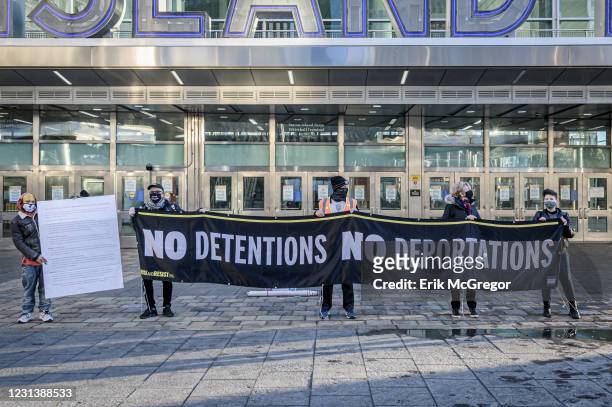 Protesters holding a banner reading NO DETENTIONS NO DEPORTATIONS at the silent protest.Members of the activist group Rise and Resist gathered at the...