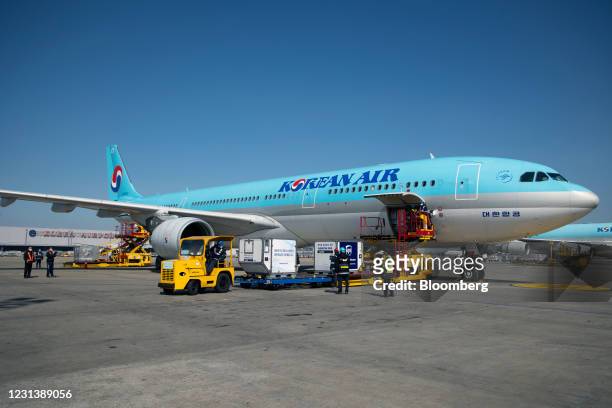 Refrigerated containers carrying the first shipment of the Pfizer Inc.-BioNTech SE Covid-19 vaccine are unloaded from a Korean Air Lines Co. Freight...