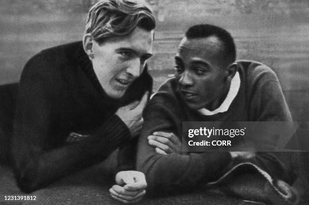 Champion Jesse Owens and German champion Luz Long chat together on the Berlin stadium 01 August 1936 during the Olympic Games where Owens captured 4...