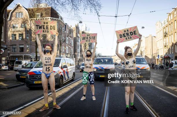 Activists protest during a demonstration by Extinction Rebellion outside the Overtoom in Amsterdam-West, as police move some of the 80 activits on,...