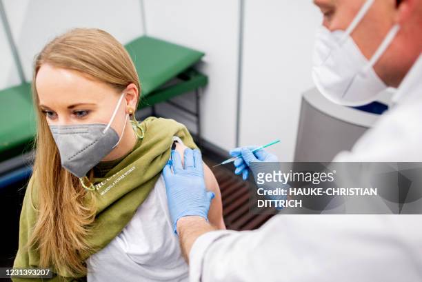 Kindergarten teacher Marie Rohlfs receives a vaccination with the Astrazeneca vaccine from medical staff Thomas Holler at the vaccination centre set...