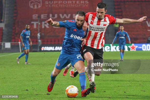 Mathieu Valbuena of Olympiacos and Nick Viergever of PSV during the UEFA Europa League Round of 32 match between PSV Eindhoven and Olympiakos Piraeus...