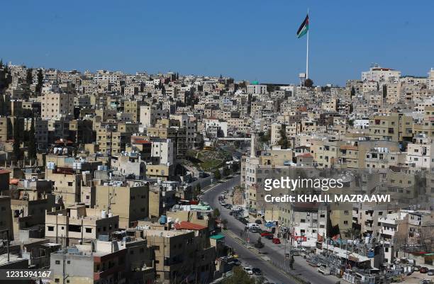 This picture shows a partial view of the Jordanian capital Amman and an almost deserted avenue during a lockdown due to the coronavirus panemic, on...