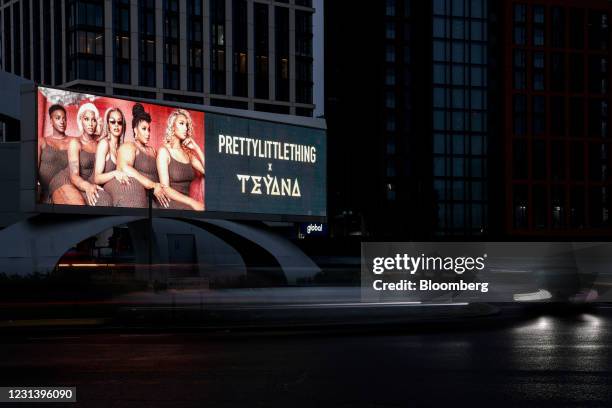 An advertisement for PrettyLittleThing.com Ltd. On a digital billboard at Vauxhall in London, U.K., on Monday, Feb. 22, 2021. Global brands slashed...