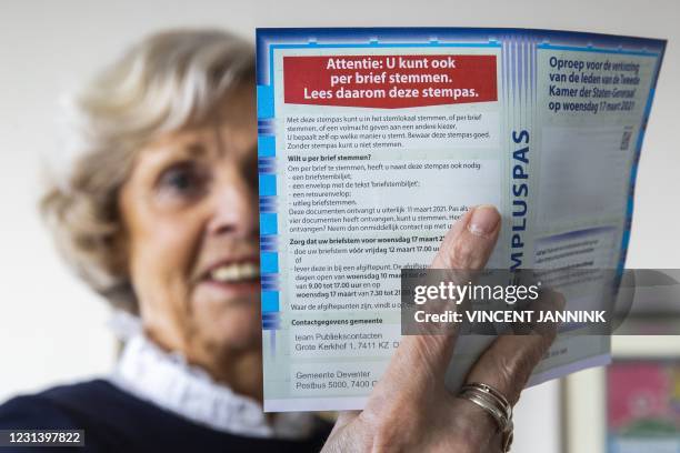 Deventer resident holds a postal voting pass in Deventer, the Netherlands, on February 26, 2021. - Due to coronavirus measures, Dutch voters over 70...