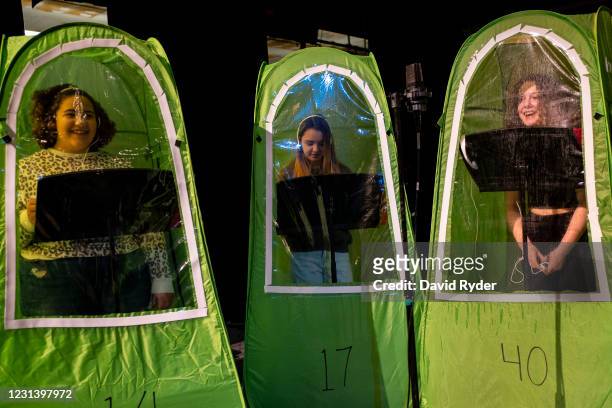 Keyonna Page-Green, Faith Colman, and Emma Banker record vocals in pop-up tents during choir class at Wenatchee High School on February 26, 2021 in...