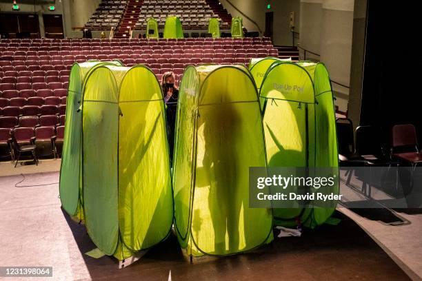 Choir director Dawn McCormick leads students as they record vocals in pop-up tents during choir class at Wenatchee High School on February 26, 2021...