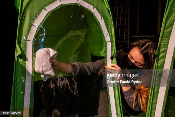 Faith Colman disinfects her pop-up tent at the end of choir class at Wenatchee High School on February 26, 2021 in Wenatchee, Washington. The school...