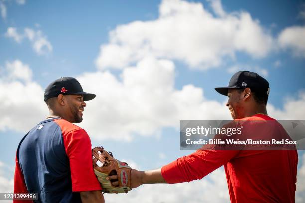 Xander Bogaerts talks with Rafael Devers of the Boston Red Sox during a spring training team workout on February 26, 2021 at jetBlue Park at Fenway...