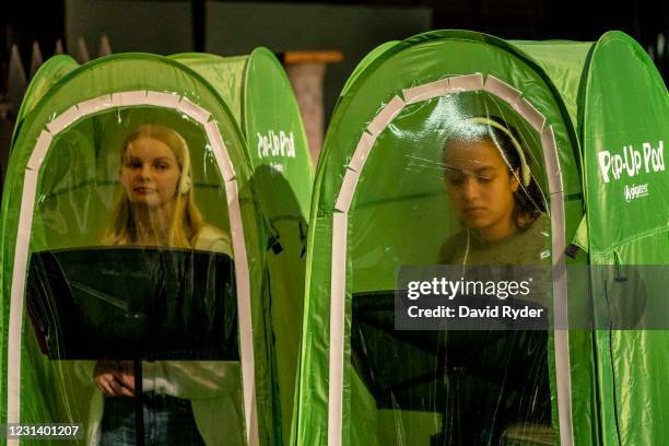 Jessi McIrvin and Valerie Sanchez record vocals in pop-up tents during choir class at Wenatchee High School on February 26, 2021 in Wenatchee,...