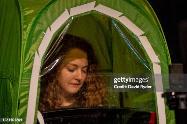 Emma Banker records vocals in a pop-up tent during choir class at Wenatchee High School on February 26, 2021 in Wenatchee, Washington. The school has...