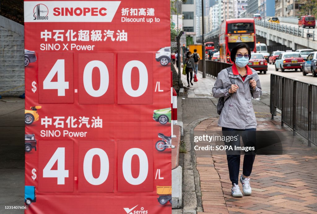 A pedestrian walks past the Chinese oil and gas enterprise...