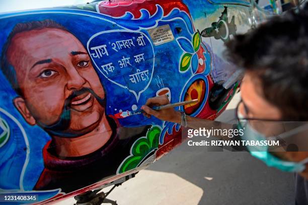 An artist gives finishing touches to a Cessna aircraft with a painted portrait of Indian Air Force pilot Abhinandan Varthaman, whose plane was shot...