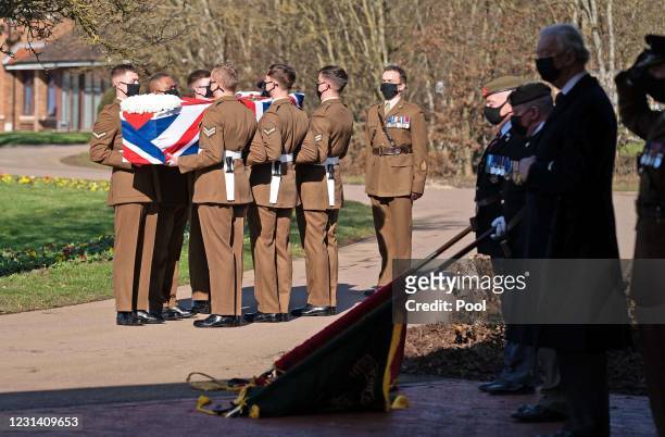 The coffin of Captain Sir Tom Moore is carried by members of the Armed Forces during his funeral at Bedford Crematorium on February 27, 2021 in...