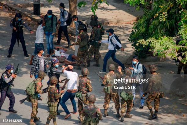 Protesters are tackled by the security forces as they crack down on demonstrations against the military coup in Monywa on February 27, 2021.