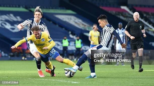 Referee Lee Mason watches as Brighton's Argentinian midfielder Alexis Mac Allister is fouled by West Bromwich Albion's English midfielder Conor...