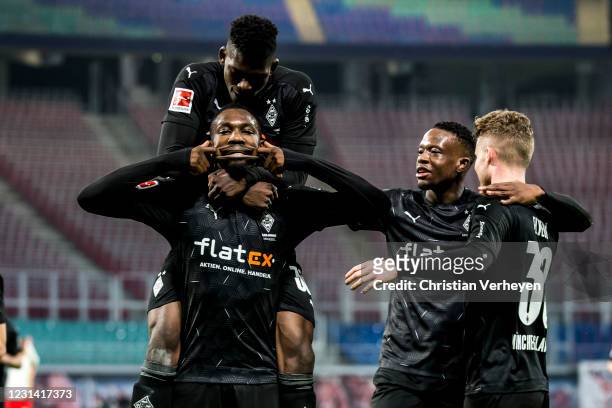 Marcus Thuram of Borussia Moenchengladbach celebrates with teammates after scoring his team's second goal during the Bundesliga match between RB...