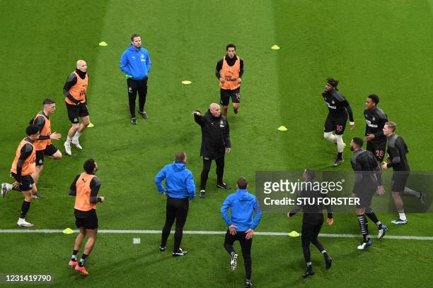 Newcastle United's First Team Coach Steve Agnew helps Newcastle players warm up ahead of the English Premier League football match between Newcastle...