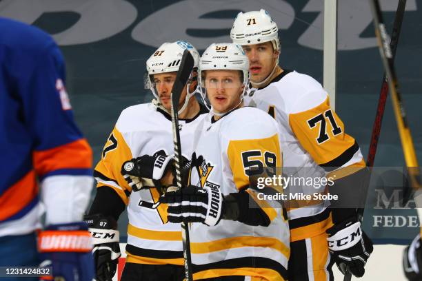 Sidney Crosby of the Pittsburgh Penguins is congratulated by Jake Guentzel and Evgeni Malkin after scoring a power-play goal against the New York...