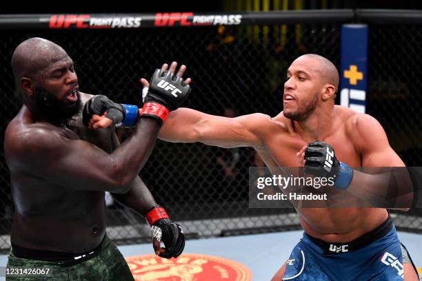 In this handout image provided by UFC, Ciryl Gane of France punches Jairzinho Rozenstruik of Suriname in a heavyweight bout during the UFC Fight...