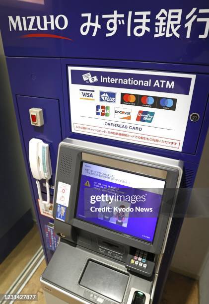 Photo taken on Feb. 28 shows a Mizuho Bank ATM in Tokyo hit by a glitch affecting cash withdrawals and other transactions at some of the major...