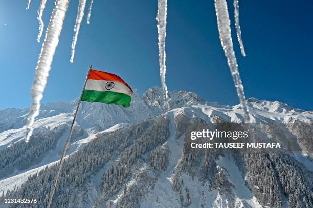 An Indian national flag is seen near Zojila mountain pass that connects Srinagar to the union territory of Ladakh, bordering China on February 28,...