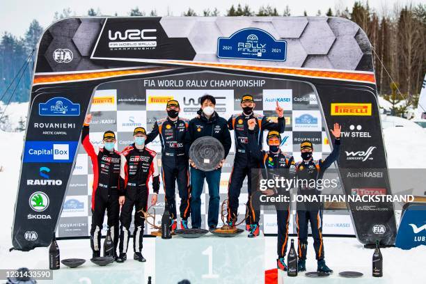 Winner Ott Tanak of Estonia and his co-driver Martin Jarveoja of Estonia together with head of the Hyundai team, Scott Noh , second placed Kalle...