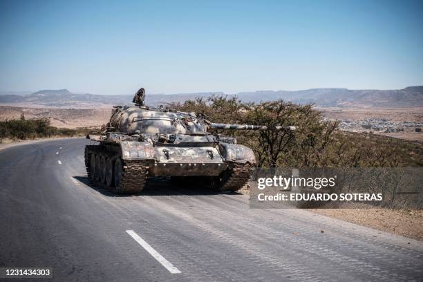 Damaged tank stands on a road north of Mekele, the capital of Tigray on February 26, 2021. - Tigray has been the theater of fighting since early...